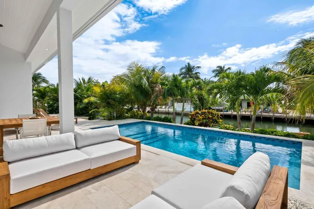 a view of swimming pool with seating area and furniture