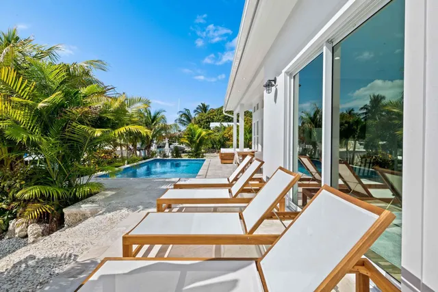 a view of a patio with couches table and chairs and potted plants