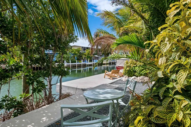 a view of a patio with table and chairs and potted plants