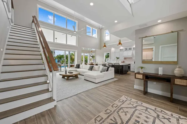 a living room with furniture and a chandelier