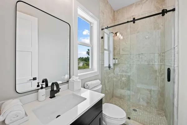 a bathroom with a sink toilet and shower