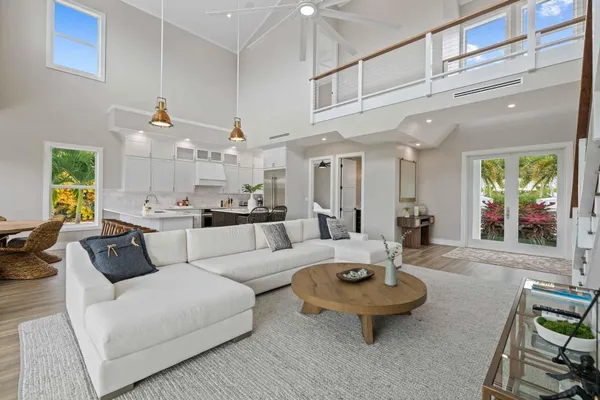 a living room with furniture a rug and a large window