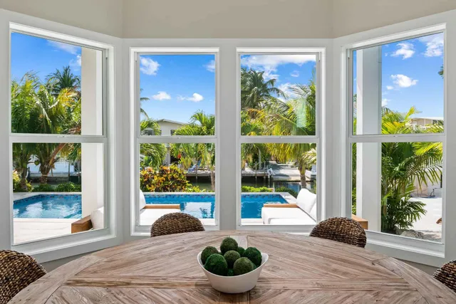 a living room filled with furniture and a large window