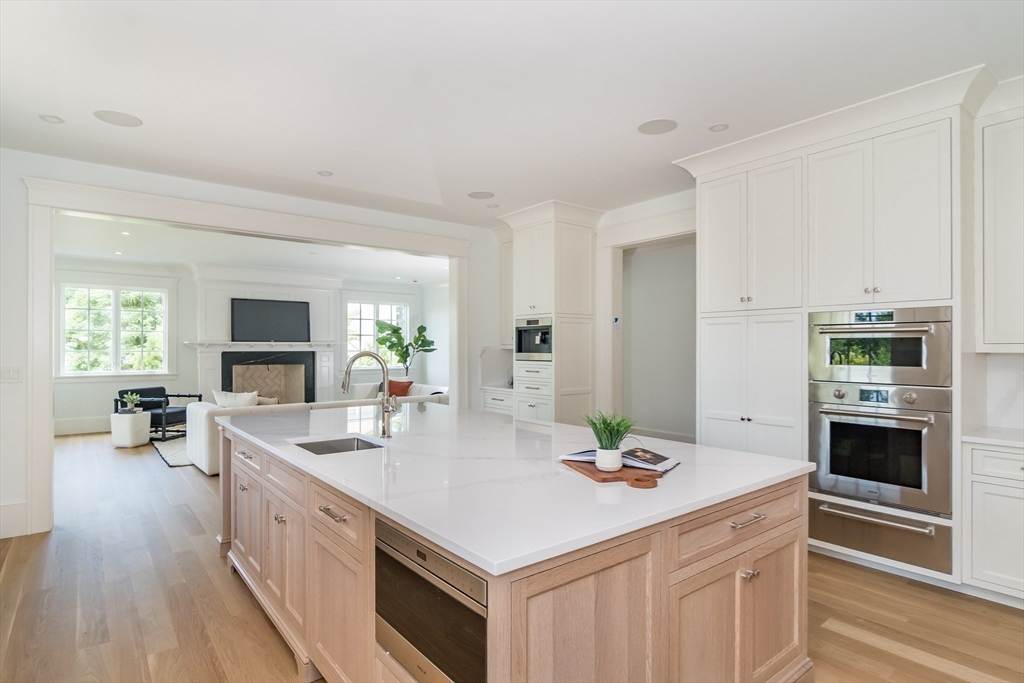 96 Love Lane Weston, MA 02493 - Photo 16 of 37 a kitchen with stainless steel appliances kitchen island granite countertop a sink stove and refrigerator