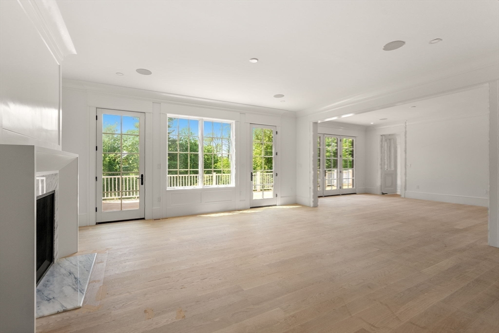 96 Love Lane Weston, MA 02493 - Photo 33 of 37 a view of a livingroom with an empty space and a fireplace