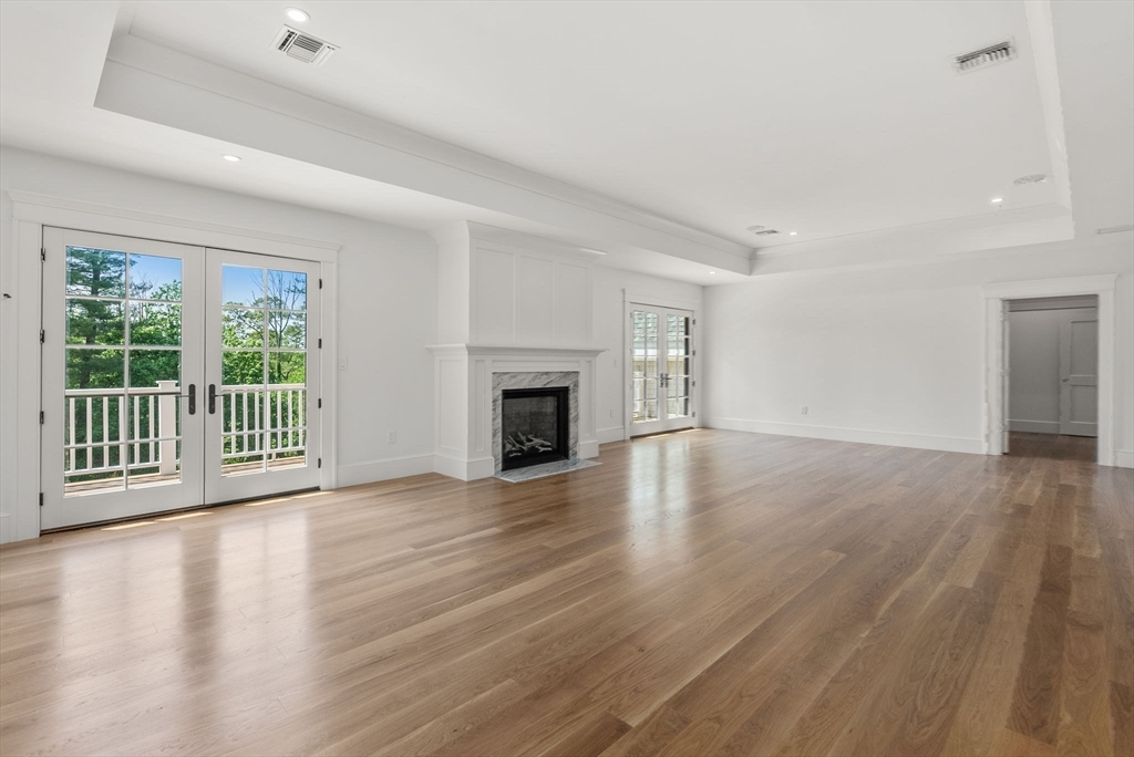 96 Love Lane Weston, MA 02493 - Photo 35 of 37 a view of an empty room with wooden floor and a window