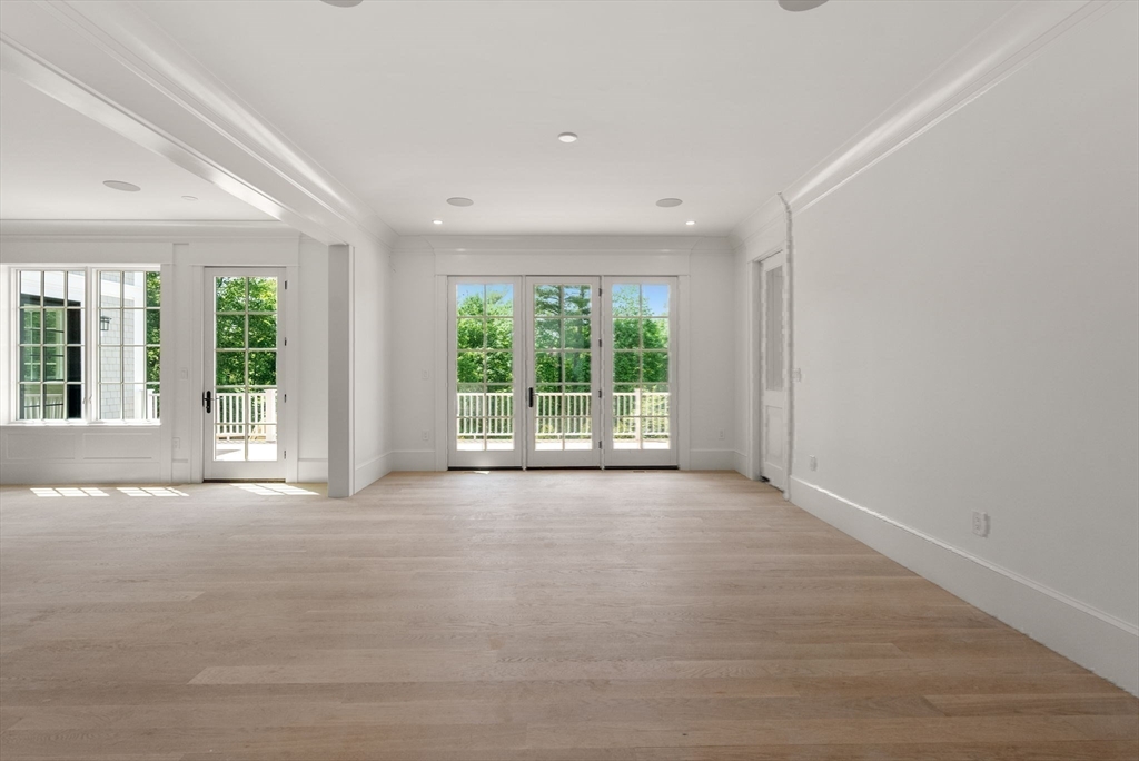 96 Love Lane Weston, MA 02493 - Photo 36 of 37 a view of an empty room with wooden floor and a window