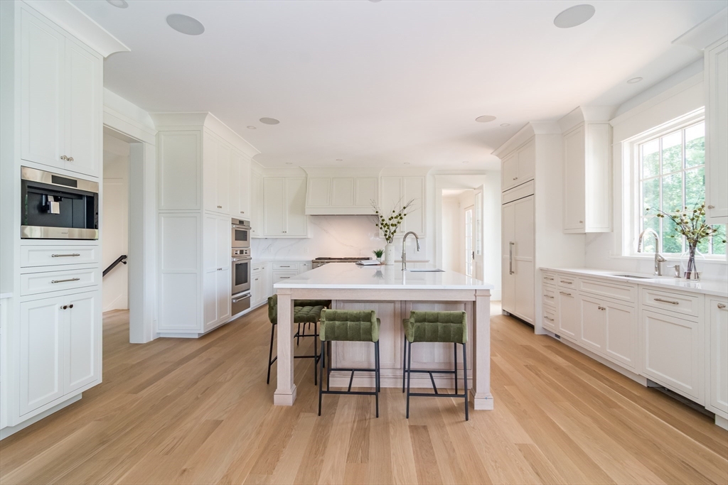 96 Love Lane Weston, MA 02493 - Photo 10 of 37 a kitchen with white cabinets and wooden floor