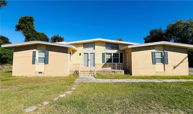 a front view of a house with a yard