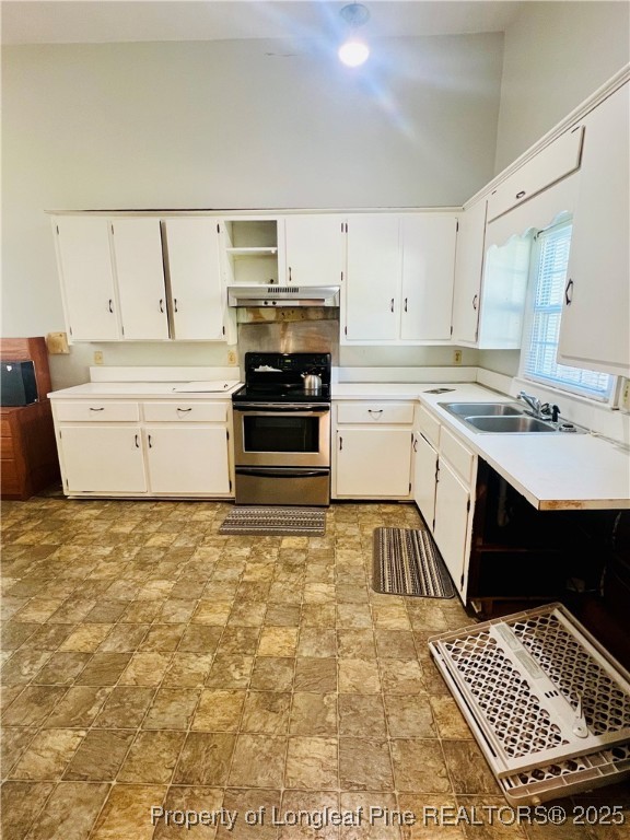 1505 7th Street Lumberton, NC 28358 - Photo 13 of 24 a kitchen with a stove a sink and a refrigerator