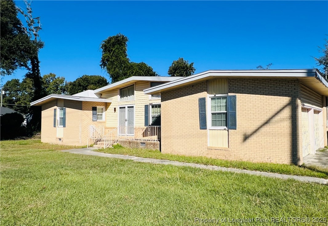 1505 7th Street Lumberton, NC 28358 - Photo 2 of 24 a front view of a house with a yard