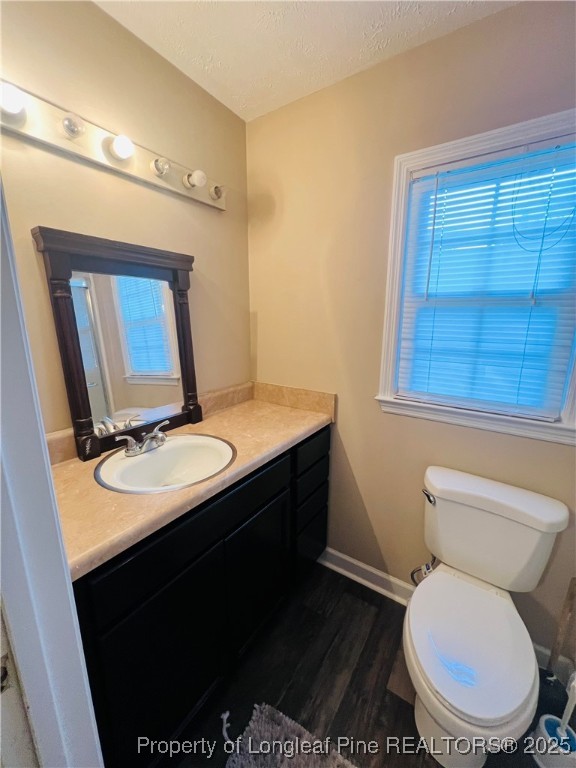 1505 7th Street Lumberton, NC 28358 - Photo 21 of 24 a bathroom with a toilet sink and mirror