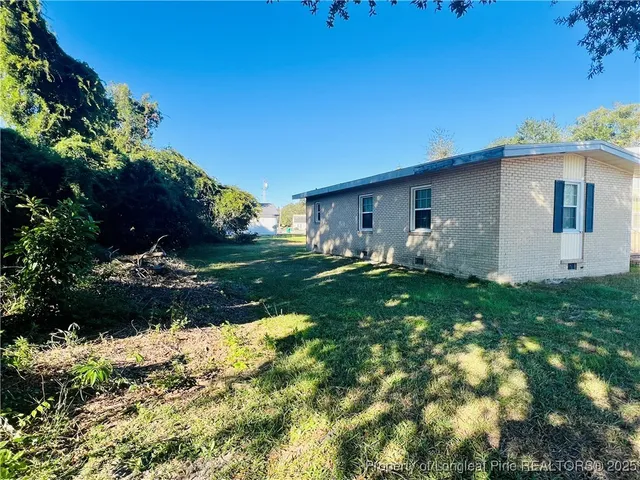 a backyard of a house with lots of green space
