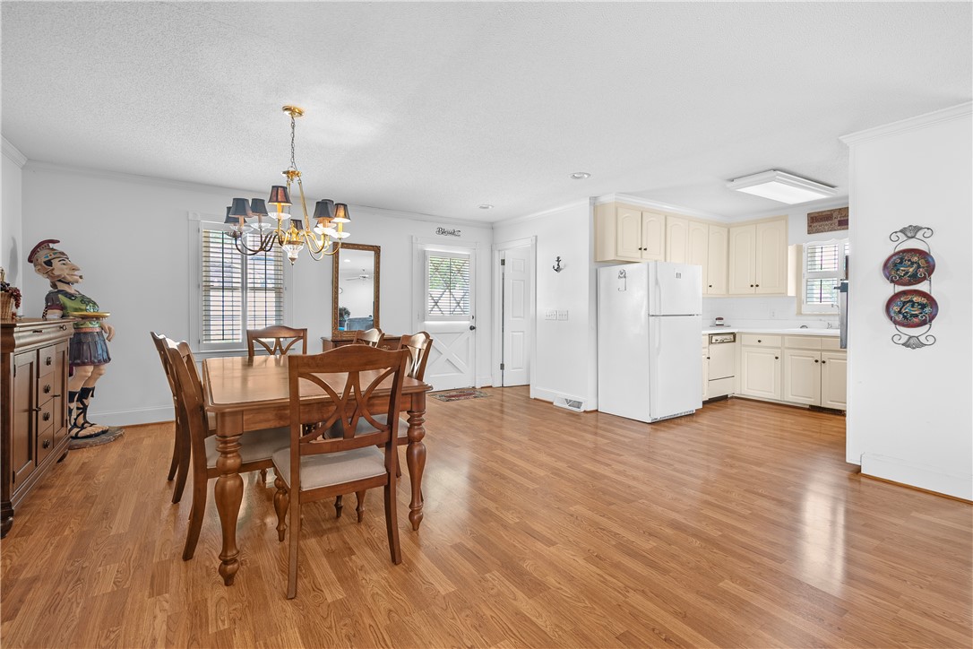 103 Pine Needle Trail Anderson, SC 29625 - Photo 13 of 41 This inviting space combines dining and kitchen areas with durable wood flooring and ample natural light.