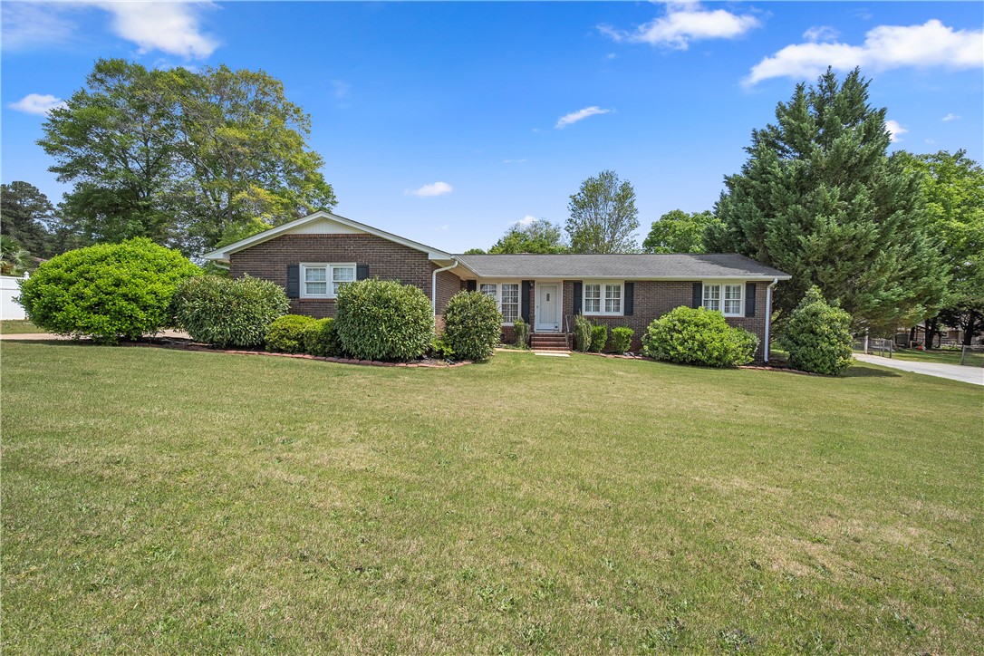 103 Pine Needle Trail Anderson, SC 29625 - Photo 2 of 41 This classic brick ranch home offers a welcoming facade with mature landscaping and a well-maintained lawn.