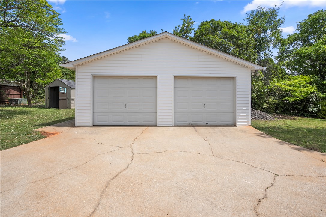 103 Pine Needle Trail Anderson, SC 29625 - Photo 32 of 41 This detached garage offers ample parking and additional storage in a serene setting.