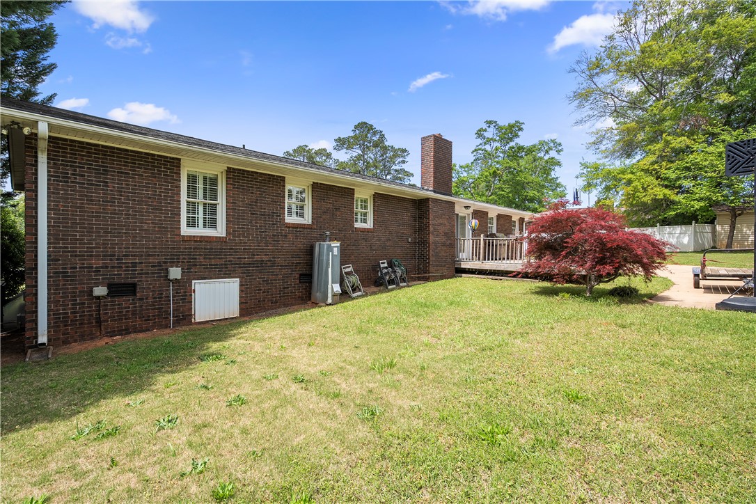 103 Pine Needle Trail Anderson, SC 29625 - Photo 35 of 41 This classic brick residence features a lush green yard and an inviting outdoor deck perfect for relaxation.