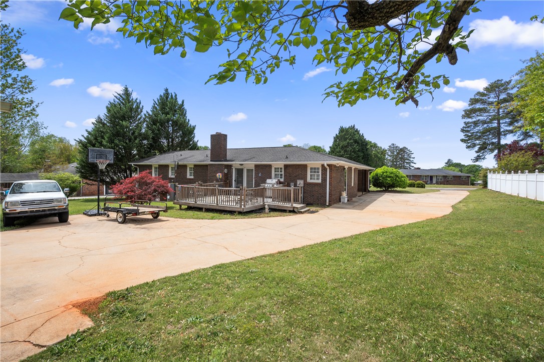 103 Pine Needle Trail Anderson, SC 29625 - Photo 37 of 41 This spacious property features a charming brick exterior with a large deck and ample outdoor living space.