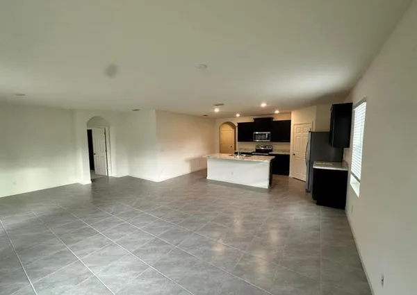 a view of a kitchen with a sink and refrigerator