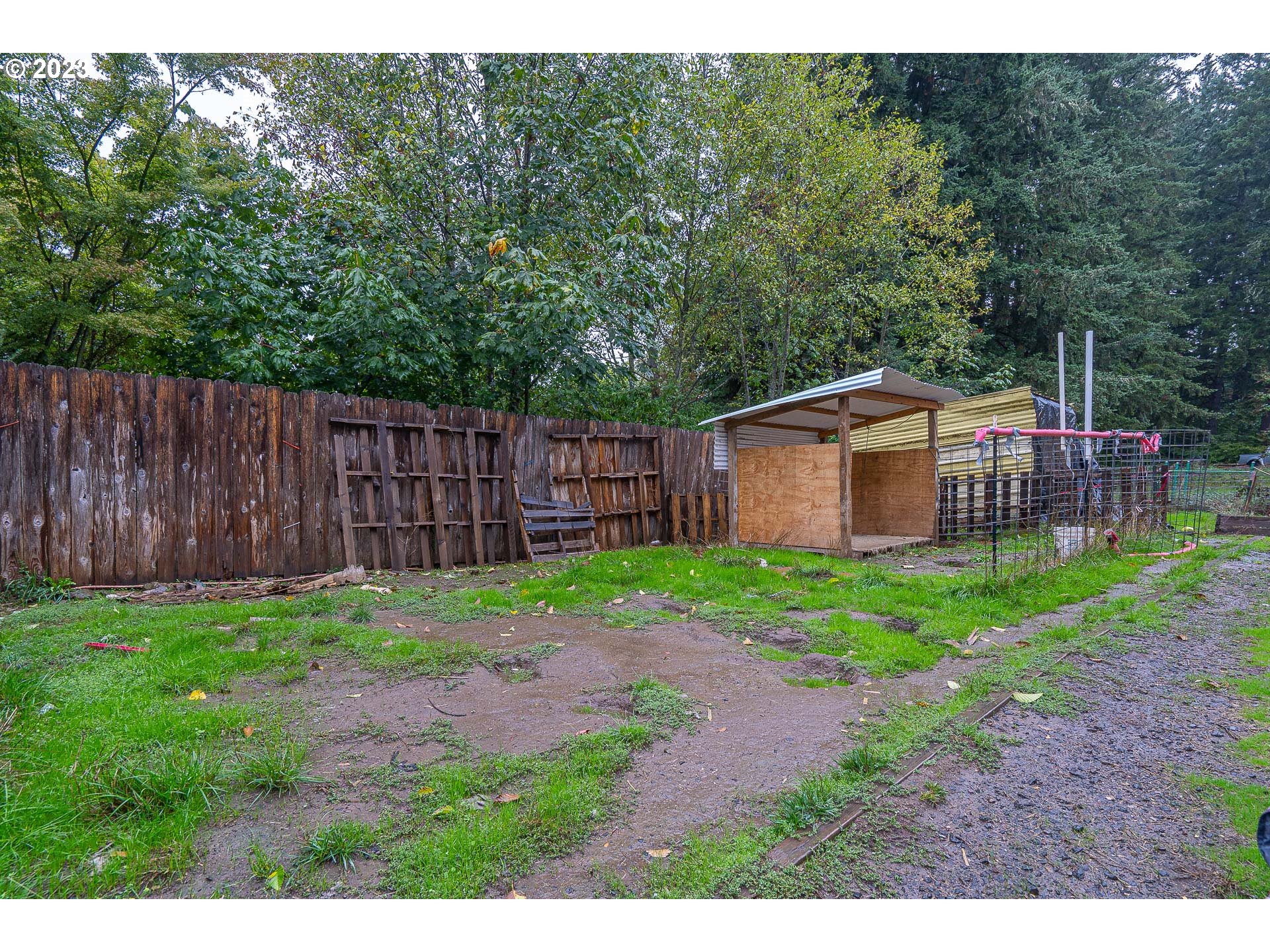22607 Noti Loop Noti, OR 97461 - Photo 28 of 29 a backyard of a house with lawn chairs and wooden fence
