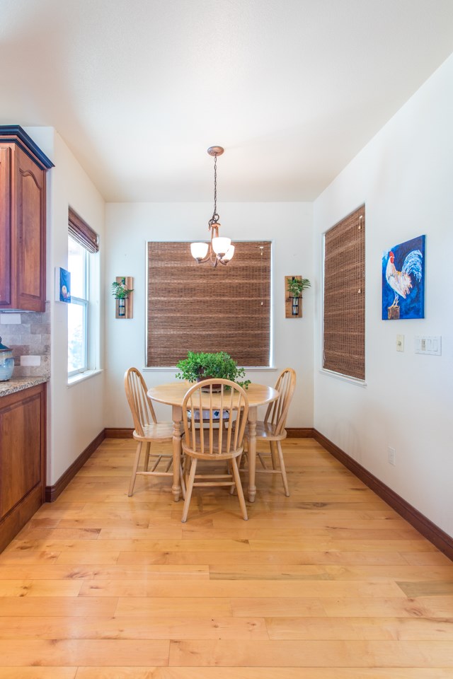 2174 M Road Grand Junction, CO 81505 - Photo 8 of 42 a dining room with furniture a chandelier and wooden floor