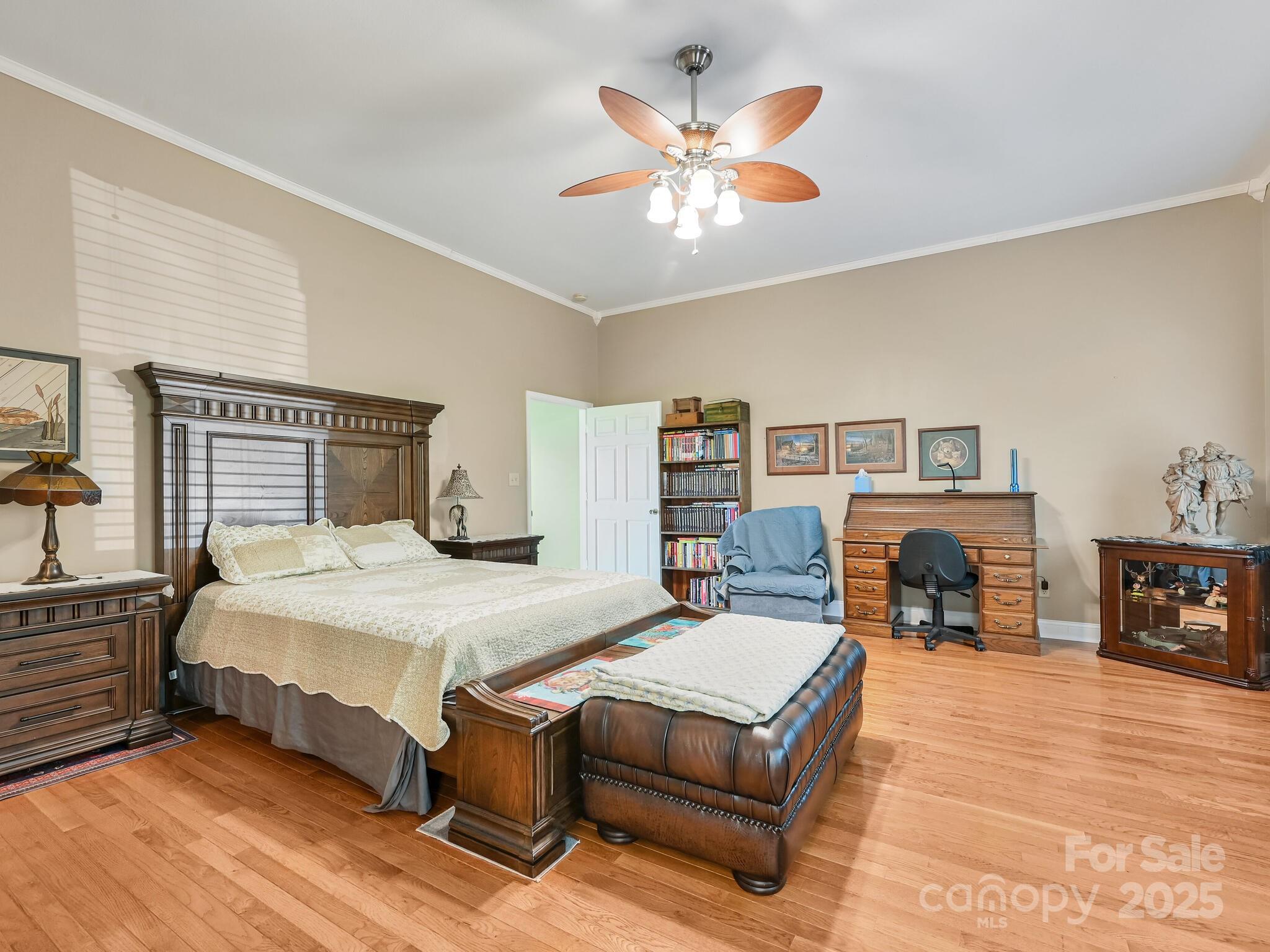 90 Coates Road Marshall, NC 28753 - Photo 13 of 48 a bedroom with a large bed a chandelier and a fireplace