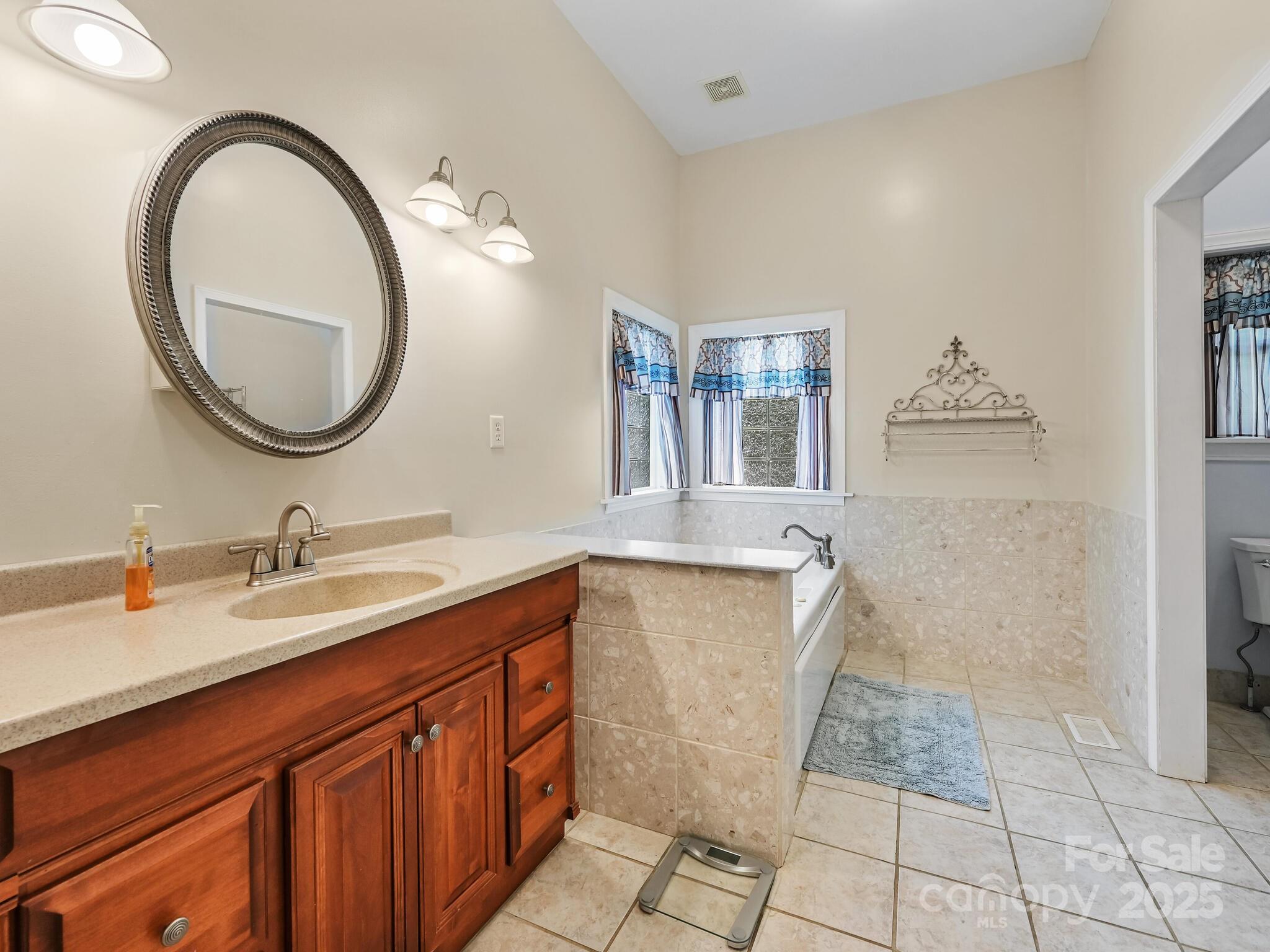 90 Coates Road Marshall, NC 28753 - Photo 14 of 48 a bathroom with a granite countertop sink and a mirror