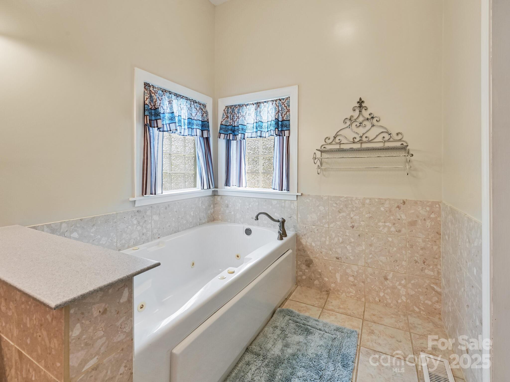 90 Coates Road Marshall, NC 28753 - Photo 15 of 48 a bathroom with a bathtub and a shower