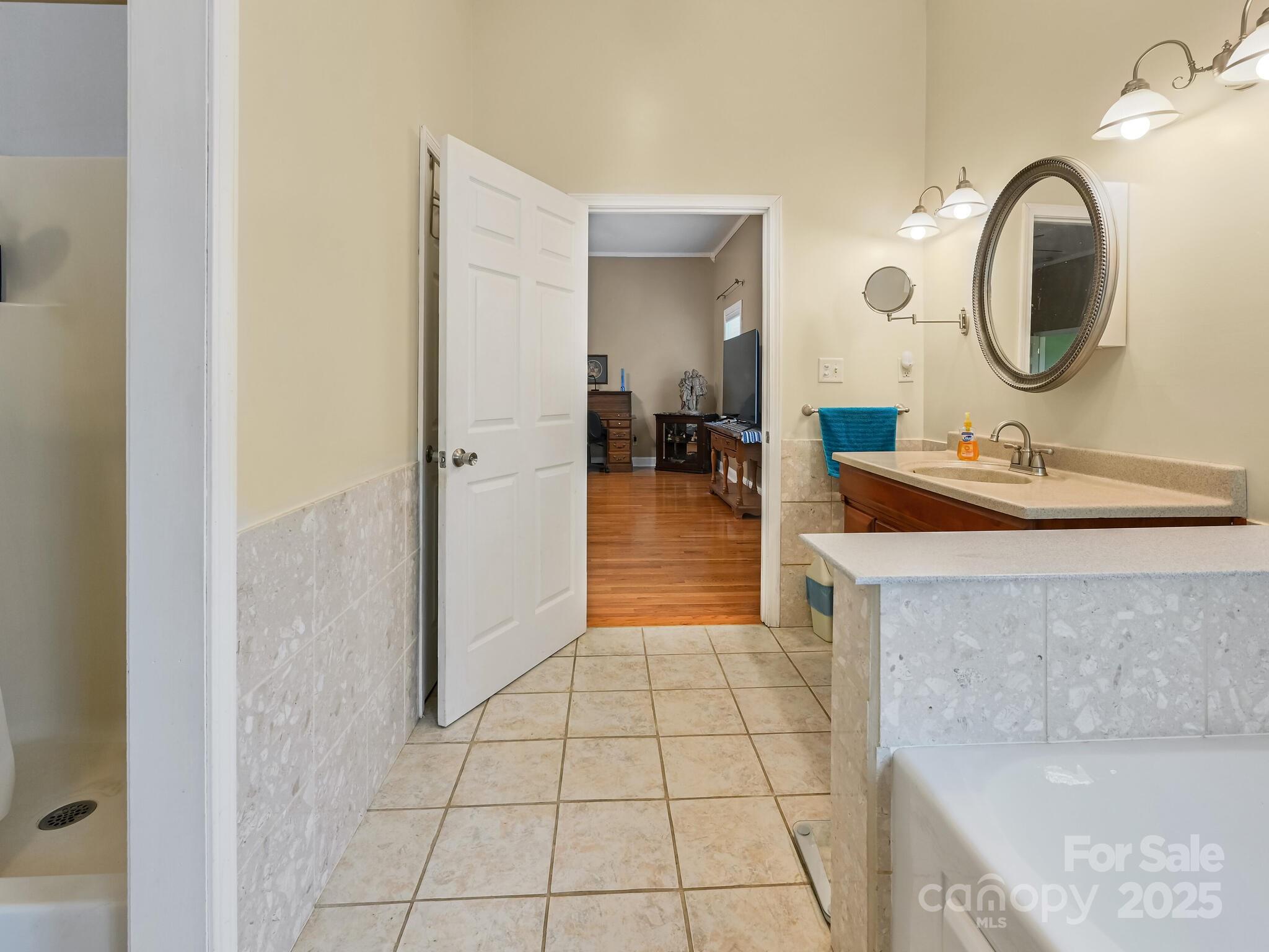 90 Coates Road Marshall, NC 28753 - Photo 16 of 48 a spacious bathroom with a sink a mirror and vanity