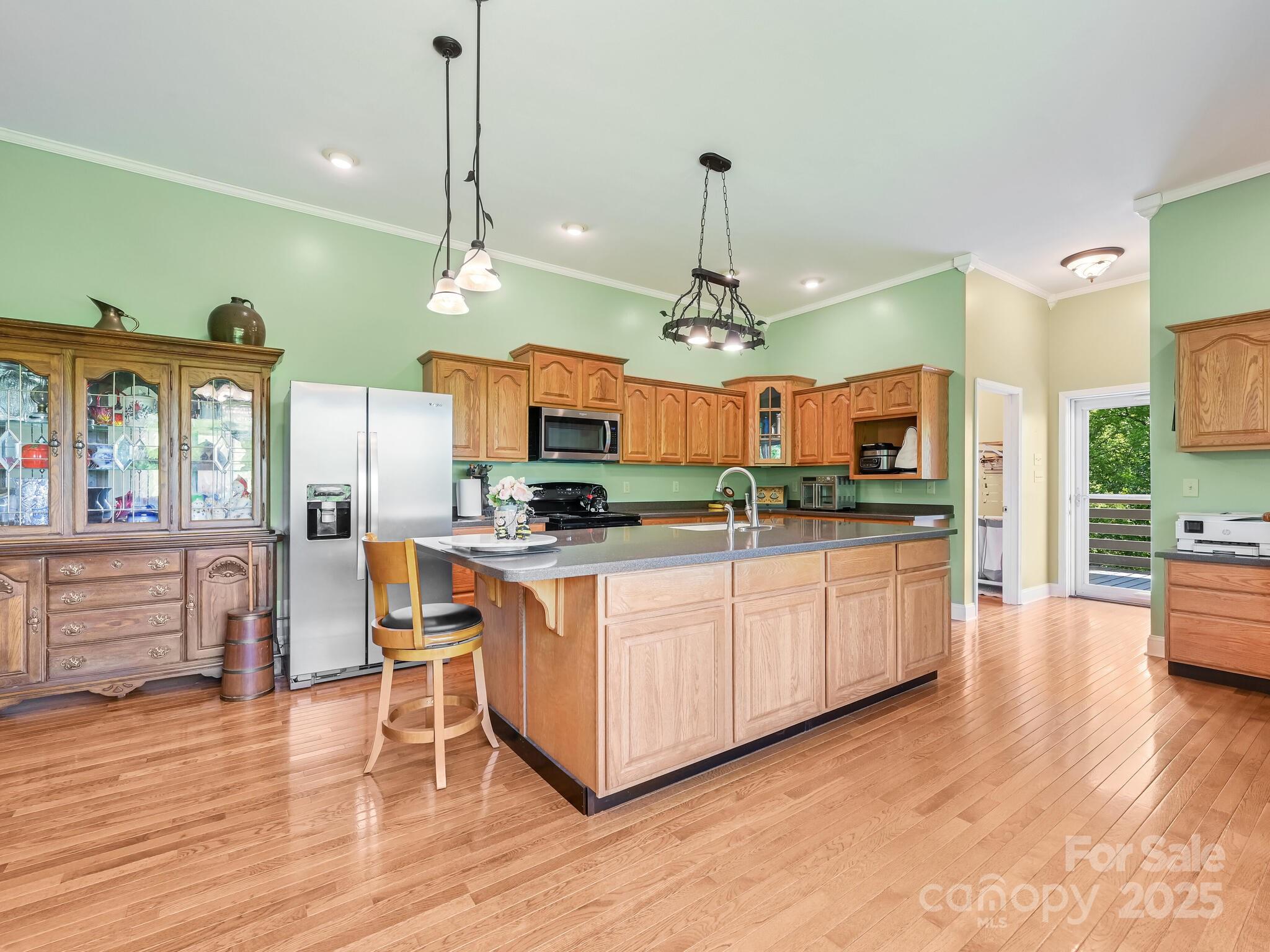 90 Coates Road Marshall, NC 28753 - Photo 20 of 48 a large kitchen with granite countertop a large island in the center and stainless steel appliances