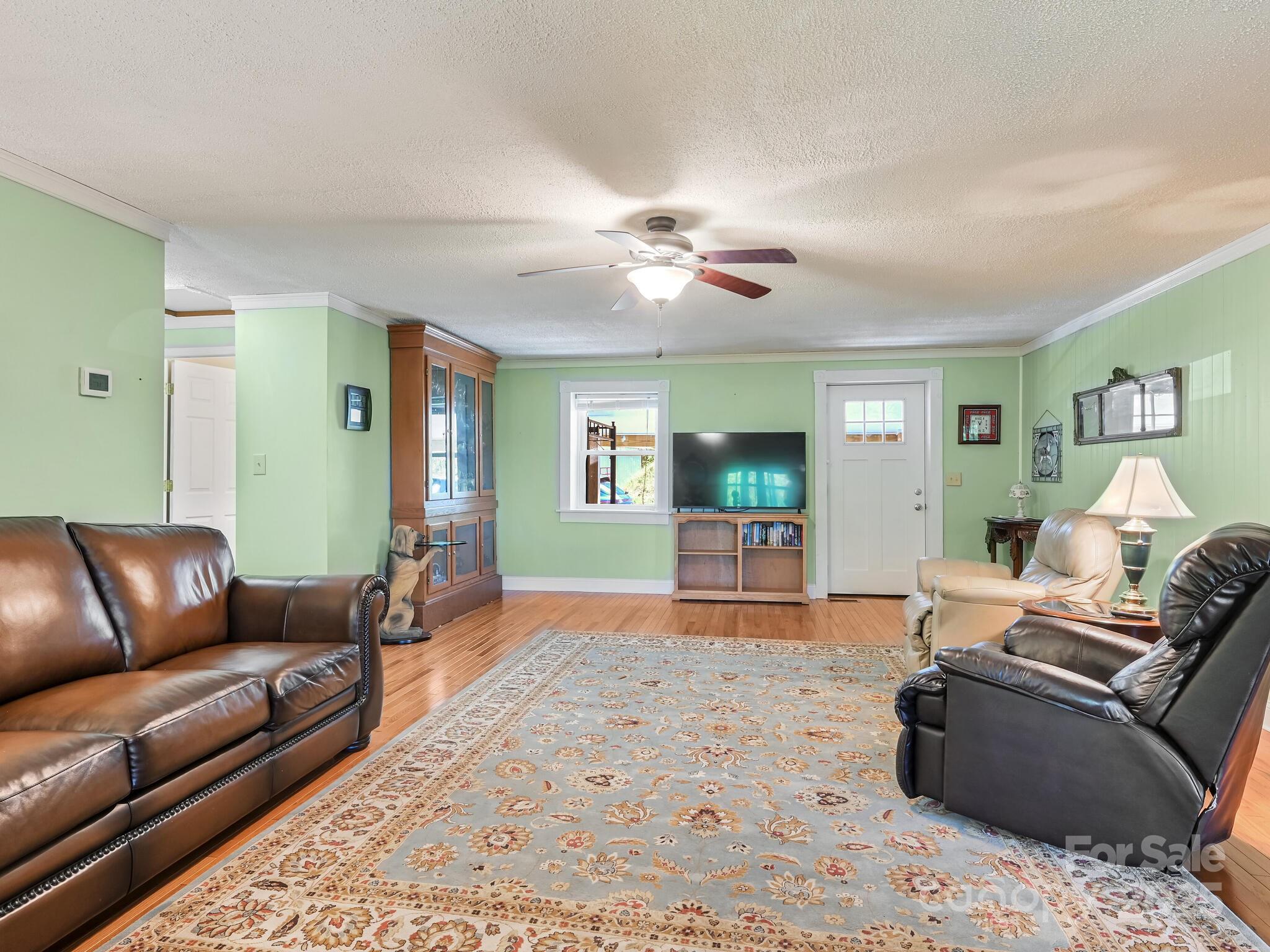 90 Coates Road Marshall, NC 28753 - Photo 5 of 48 a living room with furniture ceiling fan and a rug
