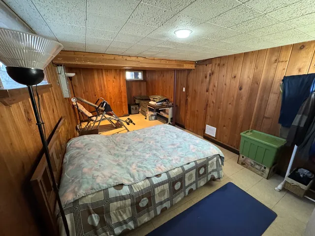 a bed sitting in a room next to a window