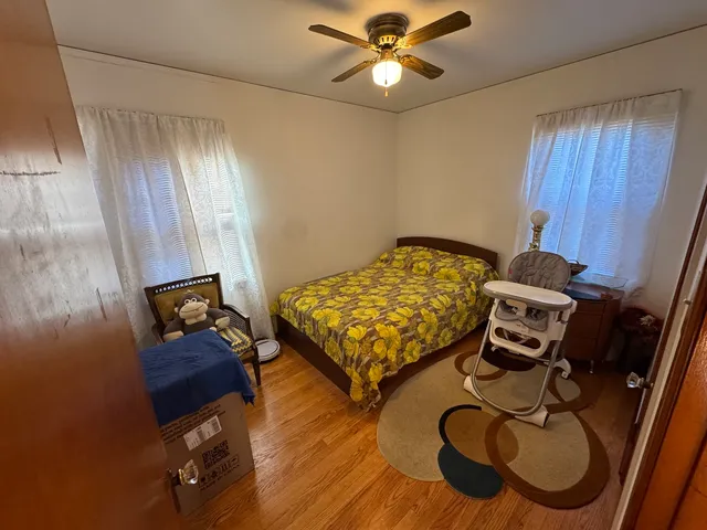 a bedroom with furniture and a wooden floor