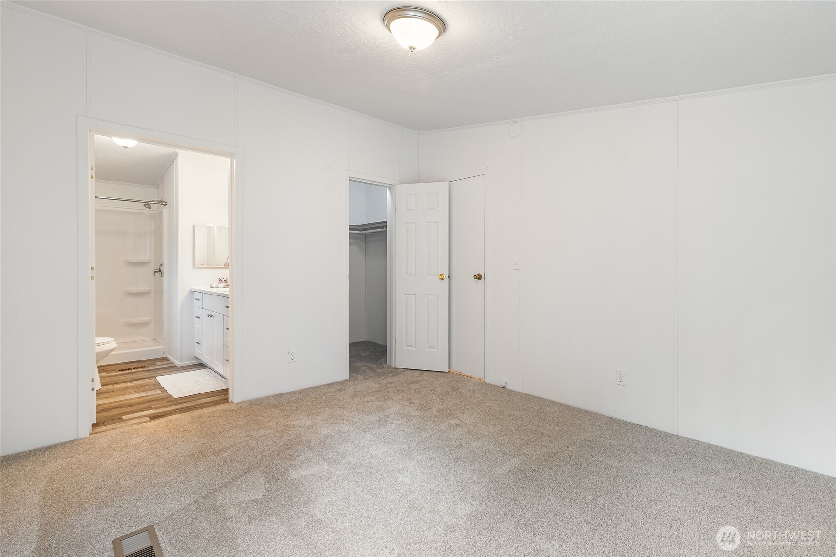 2350 Douglas Road, Unit 39 Ferndale, WA 98248 - Photo 18 of 35 an empty room with white cabinet and mirrors
