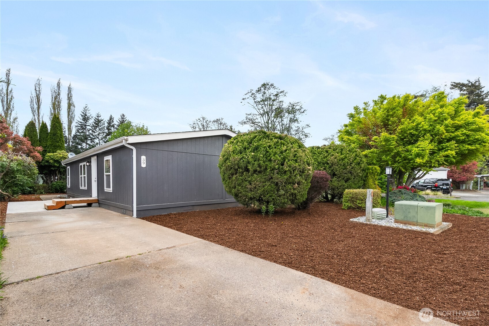 2350 Douglas Road, Unit 39 Ferndale, WA 98248 - Photo 31 of 35 a view of a backyard with plants and a bench