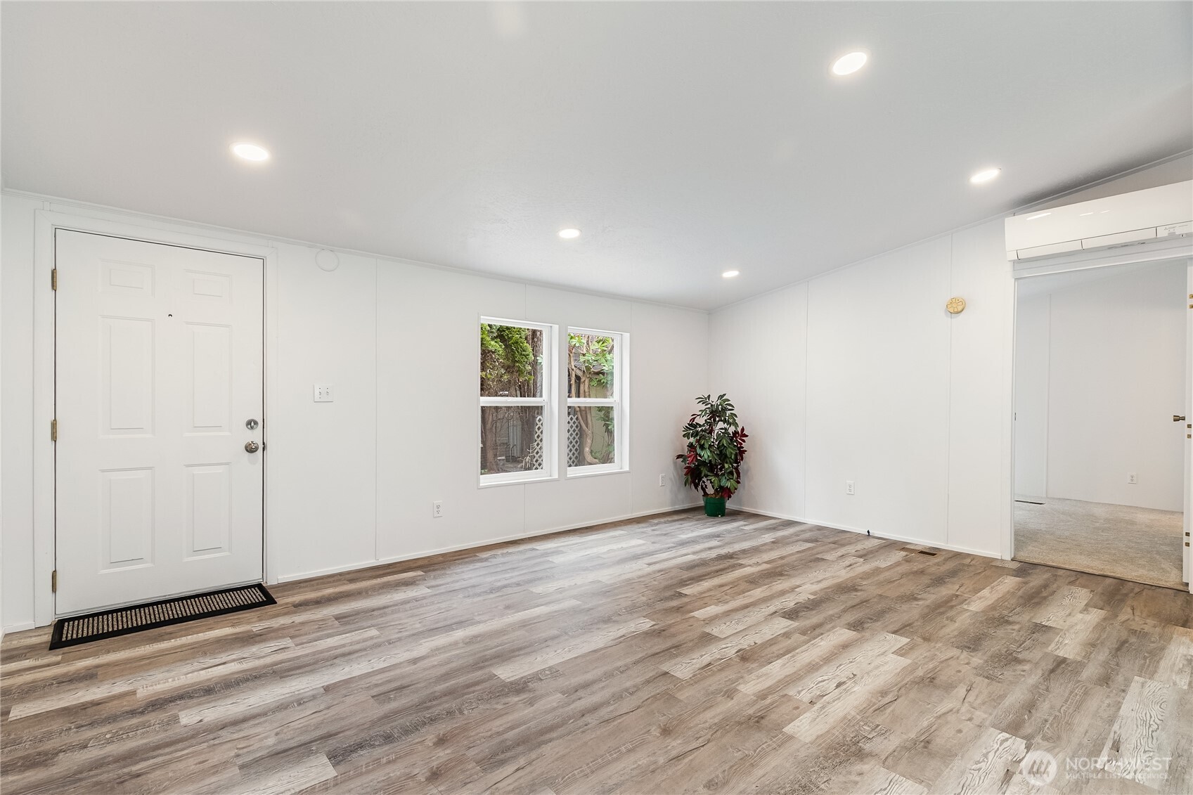 2350 Douglas Road, Unit 39 Ferndale, WA 98248 - Photo 5 of 35 a view of an empty room with wooden floor and a window