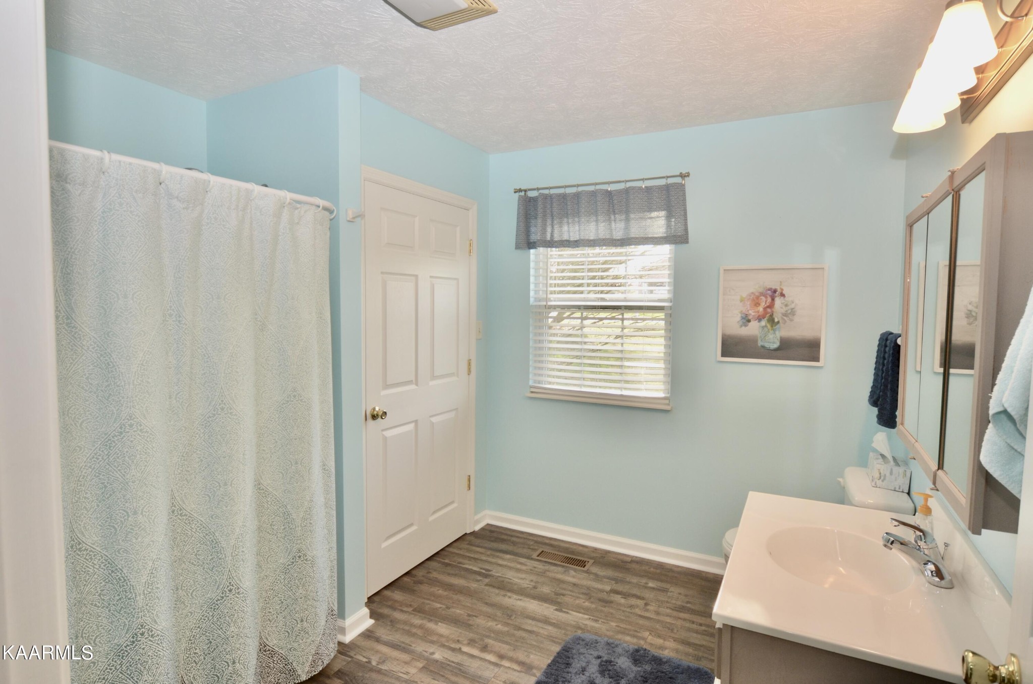 415 Sam Heim Road Rutledge, TN 37861 - Photo 17 of 41 a bathroom with a sink a mirror and a window