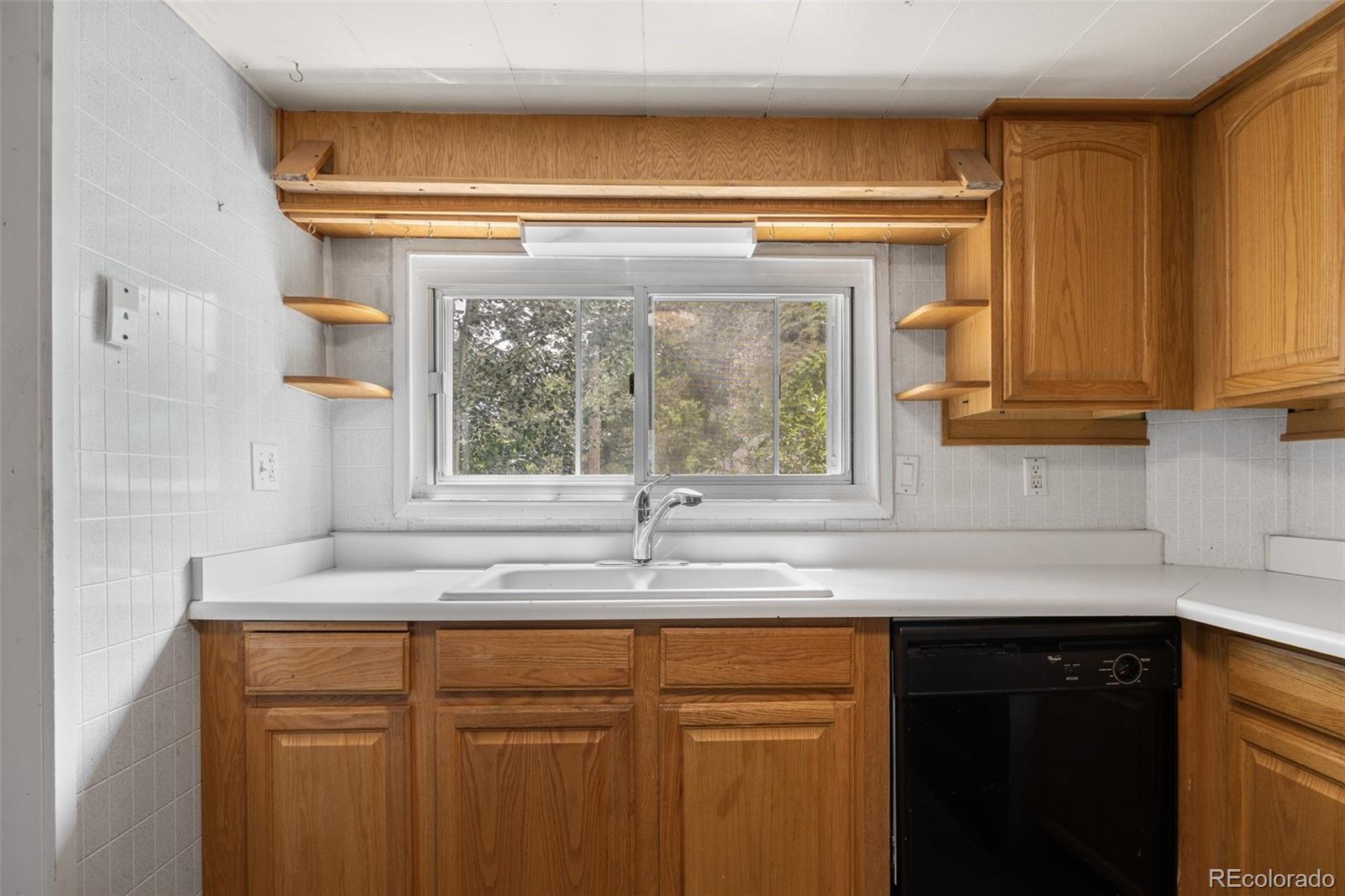 315 Spring Street Morrison, CO 80465 - Photo 14 of 40 a kitchen with granite countertop a sink and a window