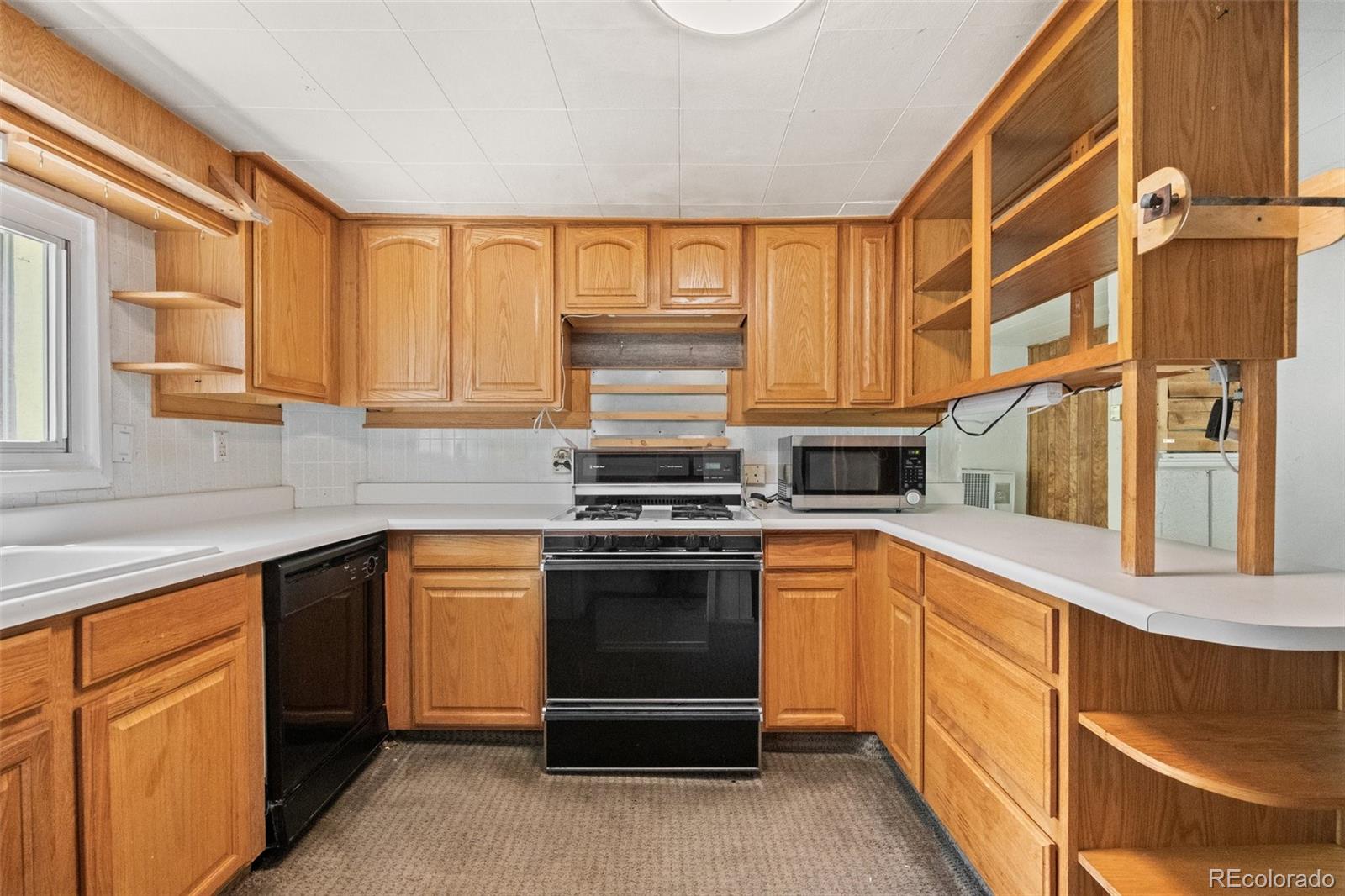 315 Spring Street Morrison, CO 80465 - Photo 15 of 40 a kitchen with stainless steel appliances granite countertop a stove and a sink