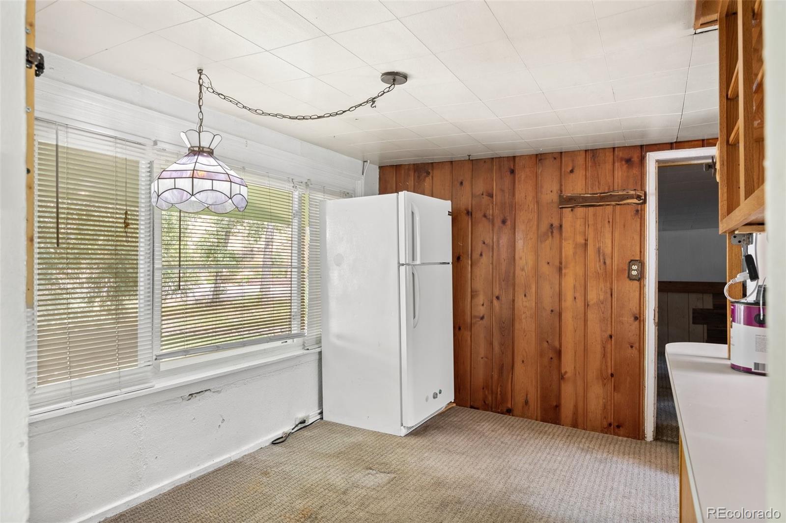 315 Spring Street Morrison, CO 80465 - Photo 17 of 40 a view of a kitchen with refrigerator and wooden floor