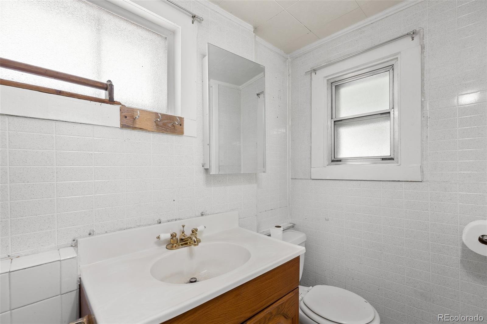 315 Spring Street Morrison, CO 80465 - Photo 21 of 40 a bathroom with a sink toilet and a mirror