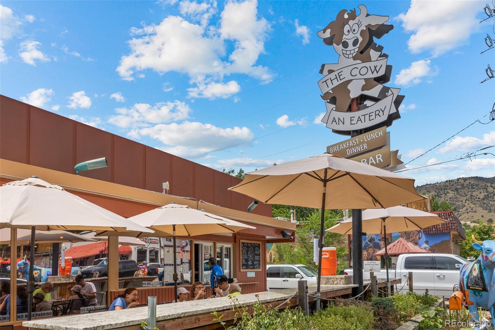 315 Spring Street Morrison, CO 80465 - Photo 32 of 40 a view of patio with a table and chairs under an umbrella