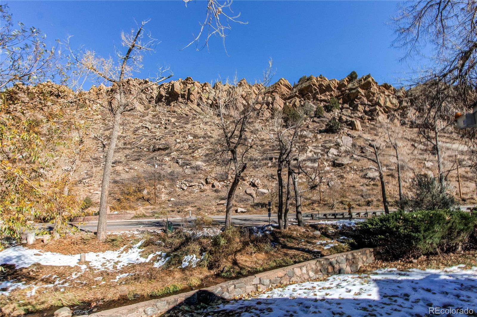 315 Spring Street Morrison, CO 80465 - Photo 8 of 40 a view of a yard with wooden fence