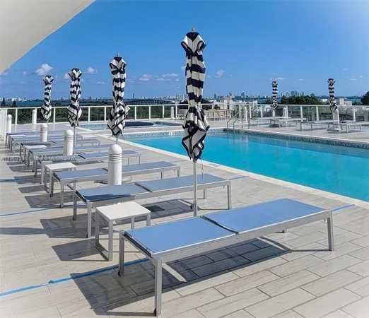 a view of a swimming pool with a lounge chairs