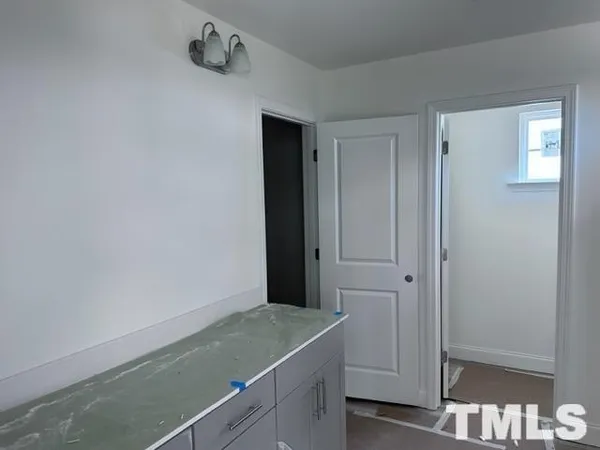 a bathroom with a granite countertop sink and vanity
