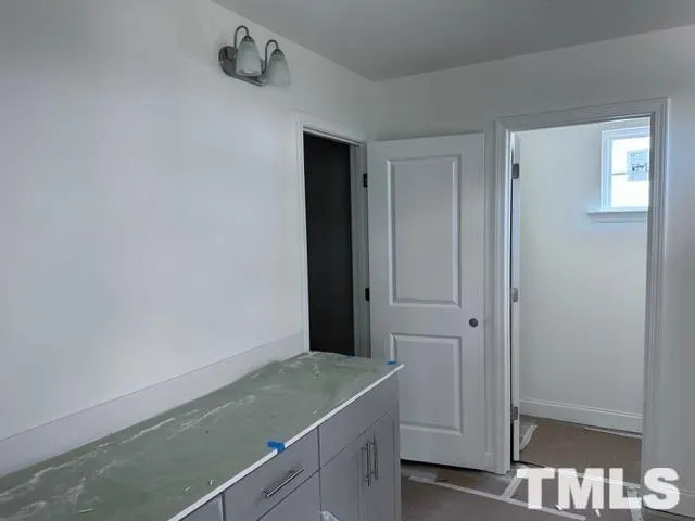 a bathroom with a granite countertop sink and vanity