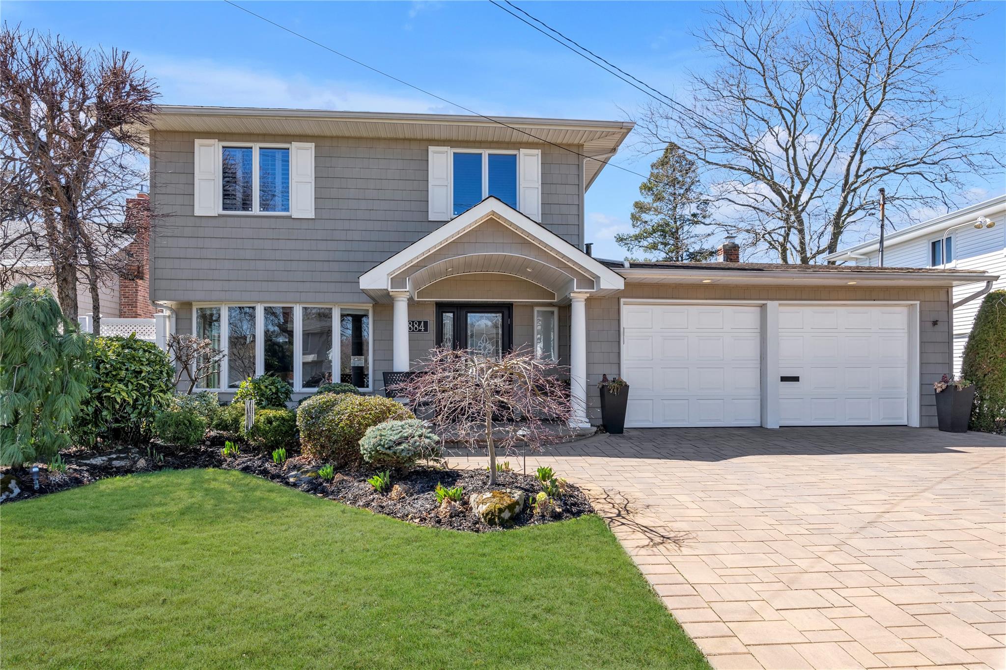 2884 Joyce Lane Merrick, NY 11566 - Photo 1 of 1 View of front of home featuring a garage, a front yard, a chimney, and driveway