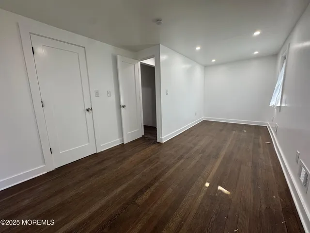 a view of hallway with wooden floor
