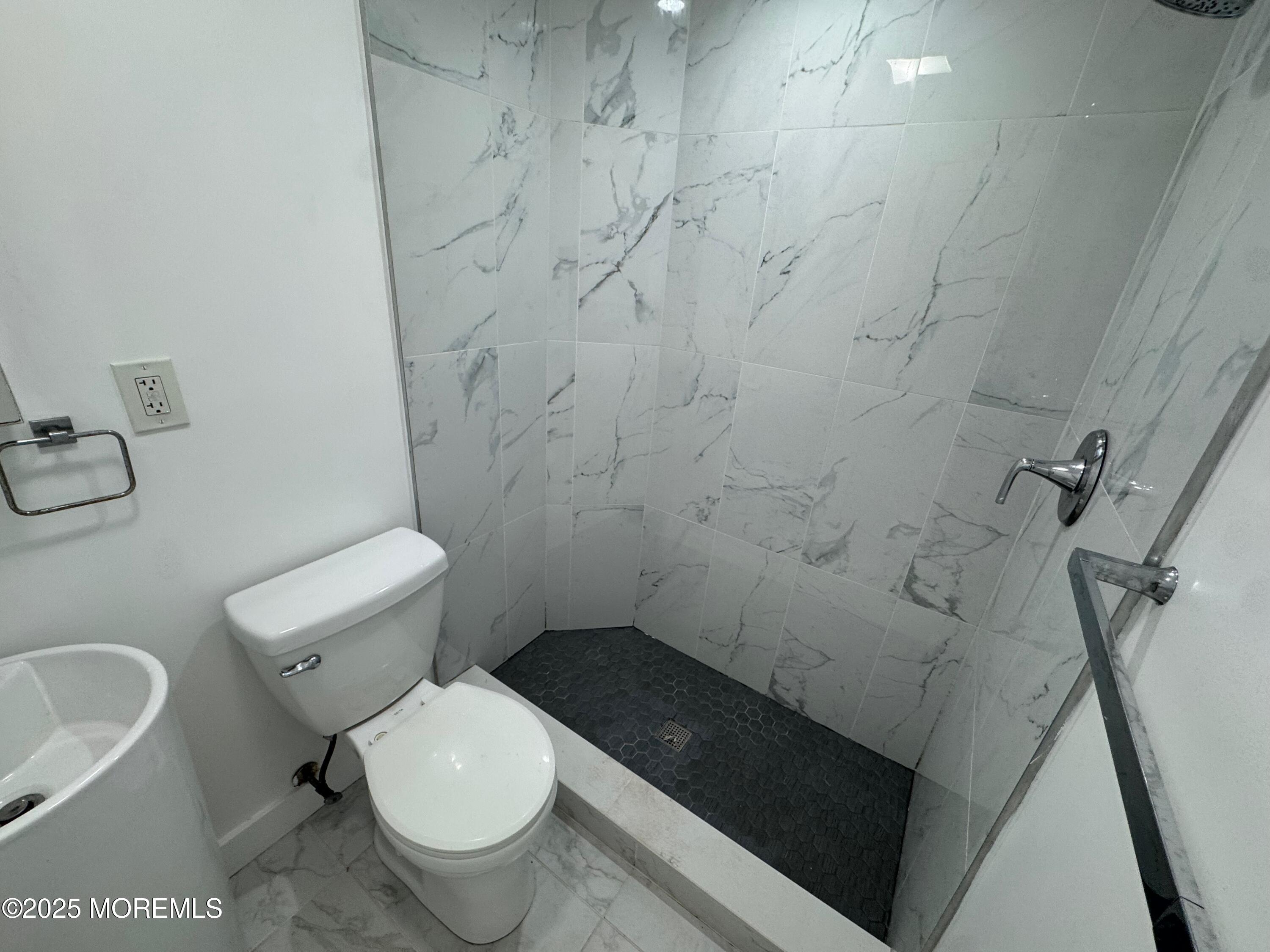 Undisclosed Address Tinton Falls, NJ 07724 - Photo 8 of 8 a white toilet sitting next to a bathroom sink and a shower