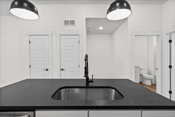 a kitchen with sink stove and refrigerator